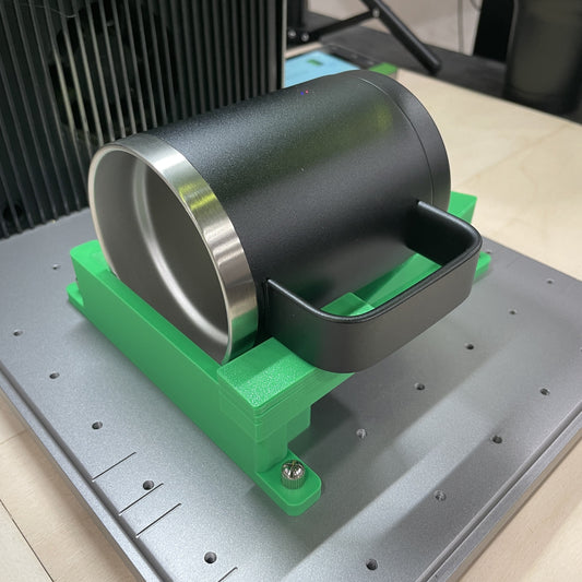 Samcraft green drinkware jig cradling a black stainless steel tumbler on the xTool F1 Ultra bed.