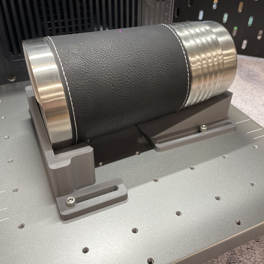 Samcraft grey drinkware jig on the xTool F2 Ultra bed, cradling a leather-wrapped stainless steel tumbler.