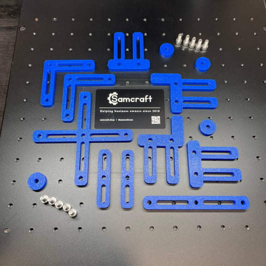Samcraft blue fence kit laid out on a ComMarker laser bed, showing the full set of rails, brackets and fixings.