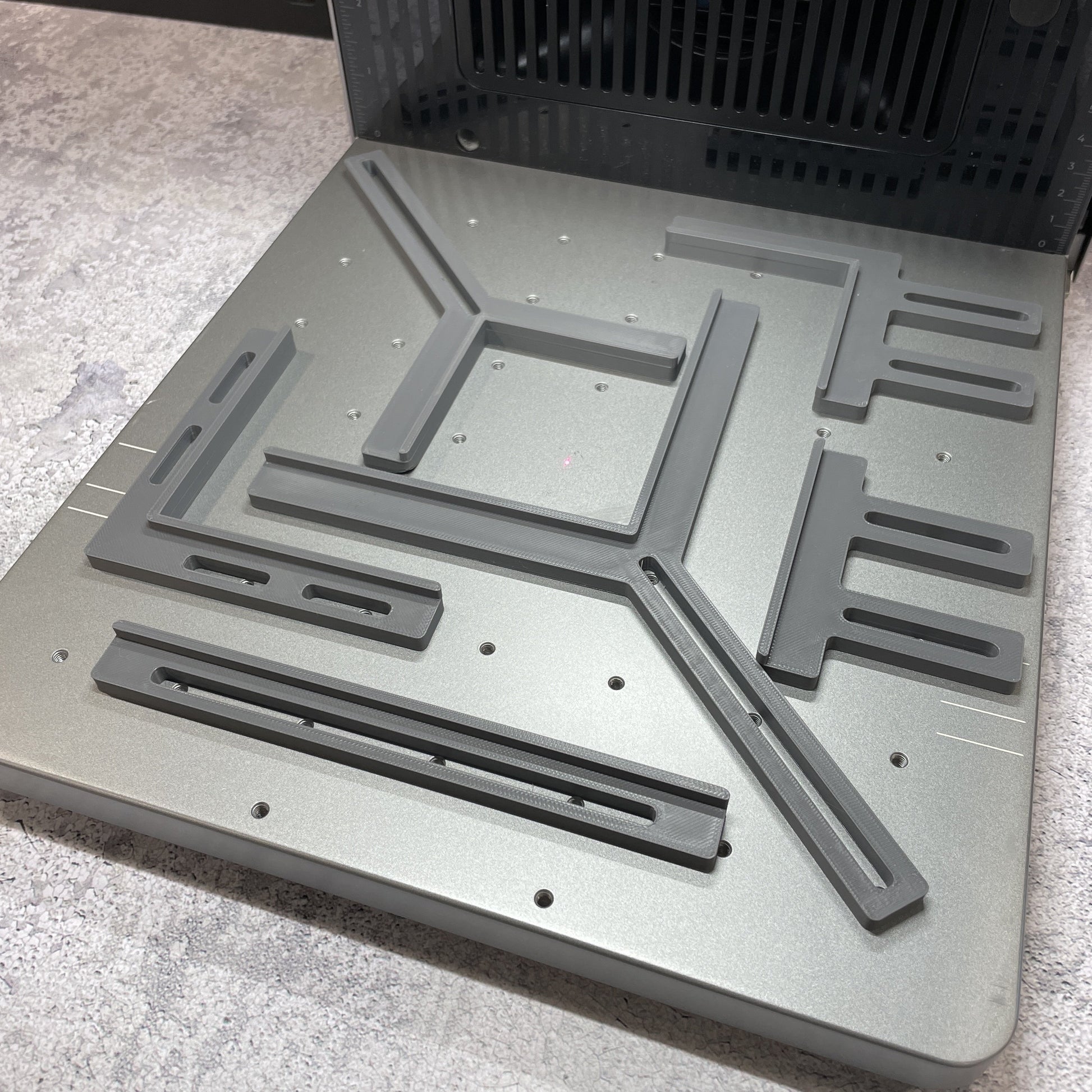 Samcraft fence kit laid out on the xTool F2 Ultra bed, showing the full set of rails and corner brackets.