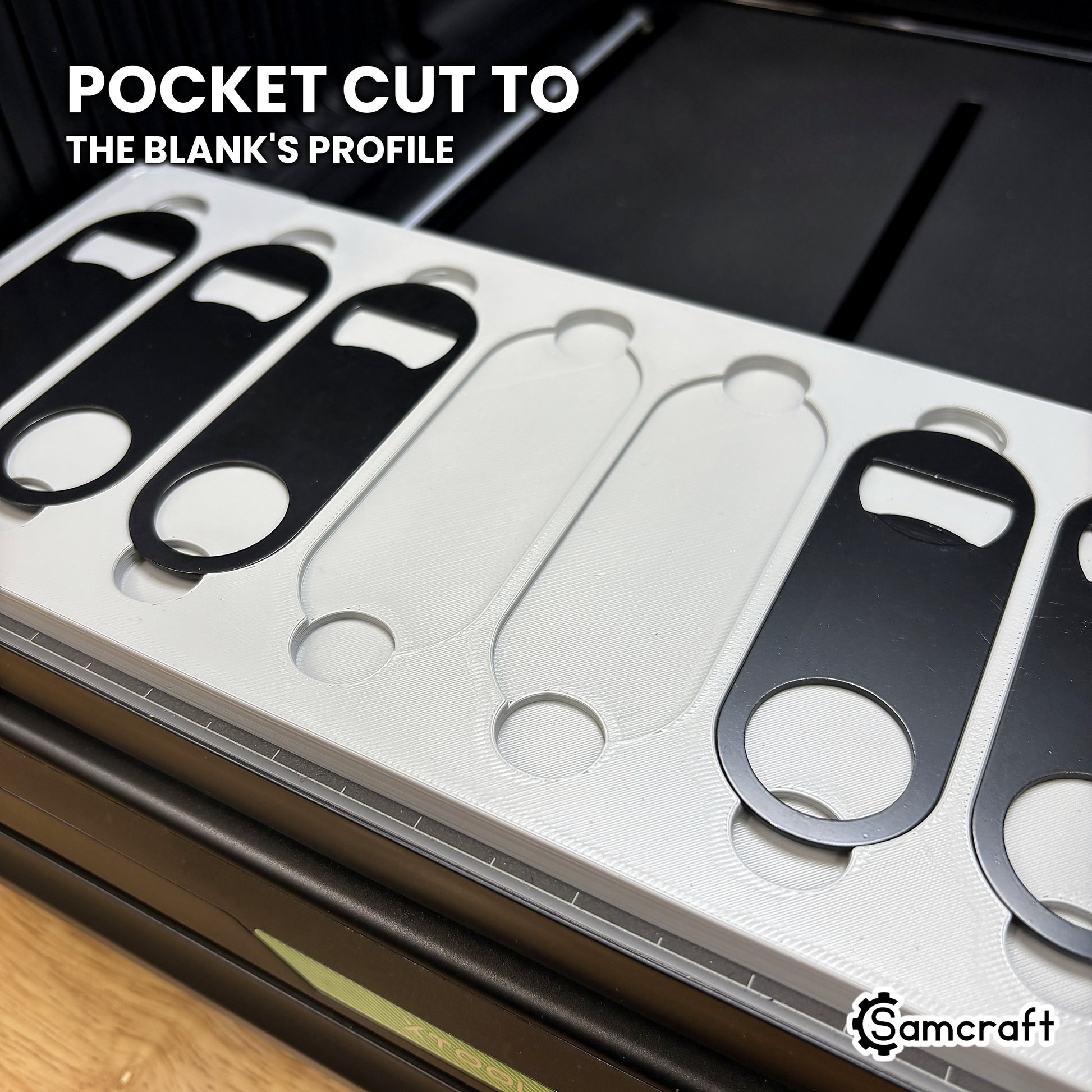 Close-up of two empty pockets in the Samcraft xTool Omni opener jig, cut to the blank's true flattened-end profile.