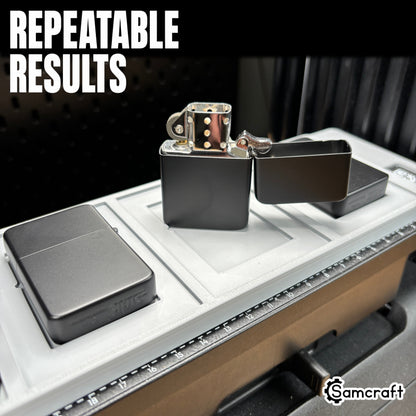 Detail of an open chrome flip-top lighter standing in the Samcraft jig alongside matte black lighters, showing repeatable results on the eufyMake E1 print bed.