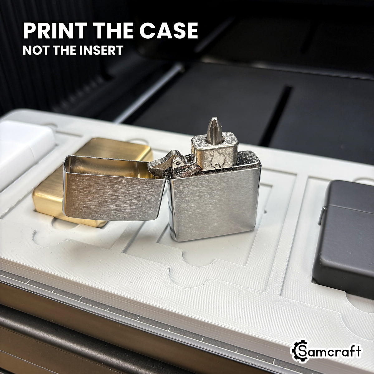 An open flip top lighter case beside seated lighters in the Samcraft xTool Omni jig, showing the case is what gets printed.