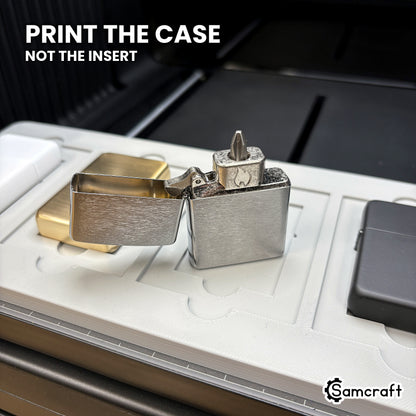 An open flip top lighter case beside seated lighters in the Samcraft xTool Omni jig, showing the case is what gets printed.