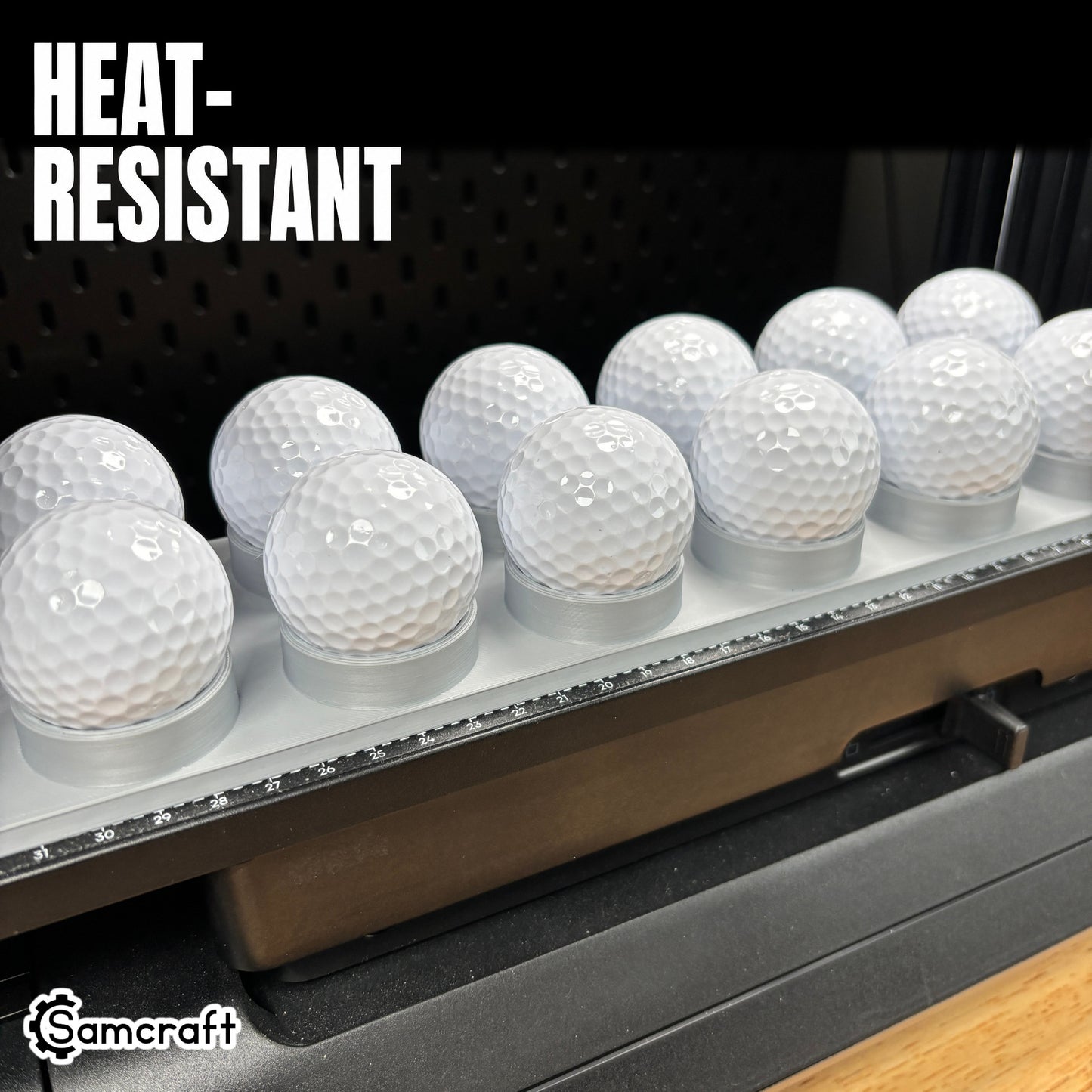 Heat-resistant Samcraft Golf Ball Jig holding white golf balls in round cradles with built-in ruler on the eufyMake E1 UV printer.