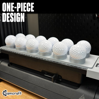 Samcraft Golf Ball Jig holding a row of white golf balls in a one-piece gray 3D-printed tray with built-in alignment ruler on the eufyMake E1 UV printer.