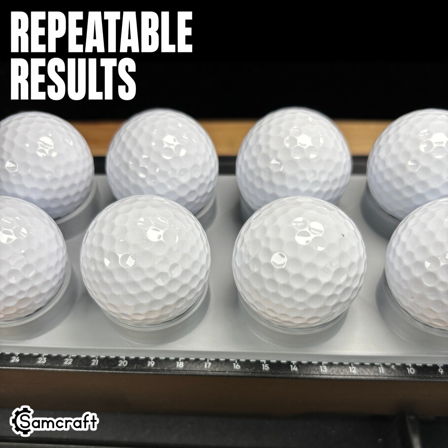 Close-up of white golf balls seated evenly in the Samcraft Golf Ball Jig's cradles, demonstrating repeatable results and the alignment ruler on the eufyMake E1.