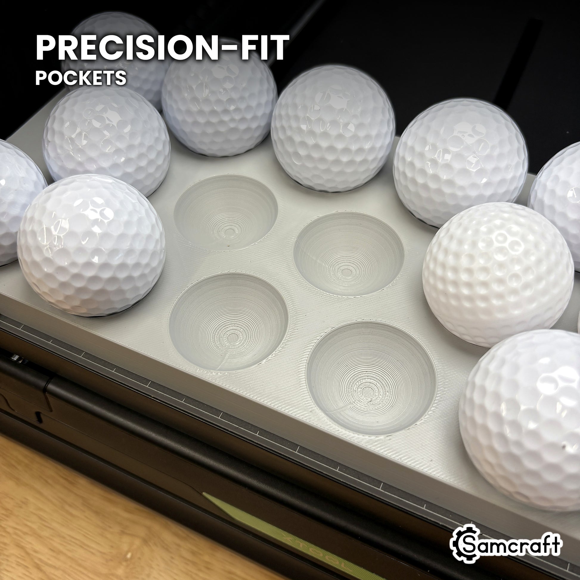 Close-up of the precision-fit ring pockets in the Samcraft golf ball jig for the xTool Omni, with golf balls seated beside empty pockets.