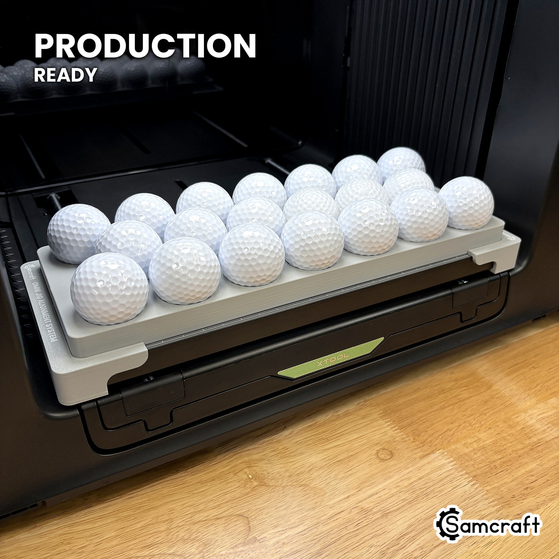 Samcraft golf ball jig loaded with twenty golf balls on the xTool Omni UV printer bed, set up for production runs.
