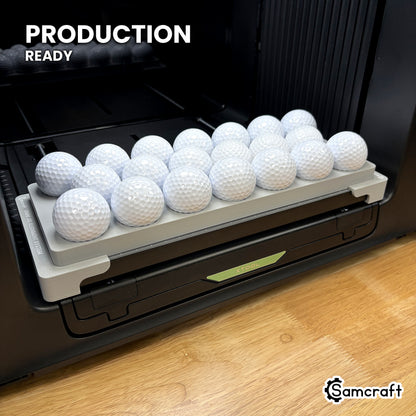 Samcraft golf ball jig loaded with twenty golf balls on the xTool Omni UV printer bed, set up for production runs.