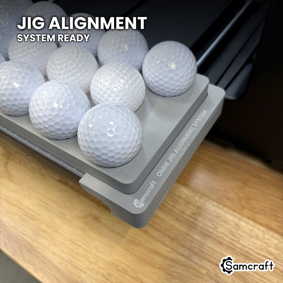 Samcraft golf ball jig seated on the optional Samcraft Omni Jig Alignment System on the xTool Omni printer bed.