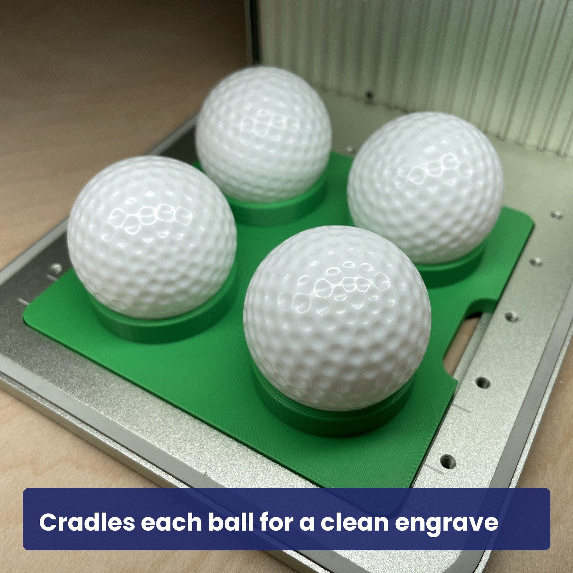 Golf balls seated in the Samcraft ball jig, each cradled square to the laser.