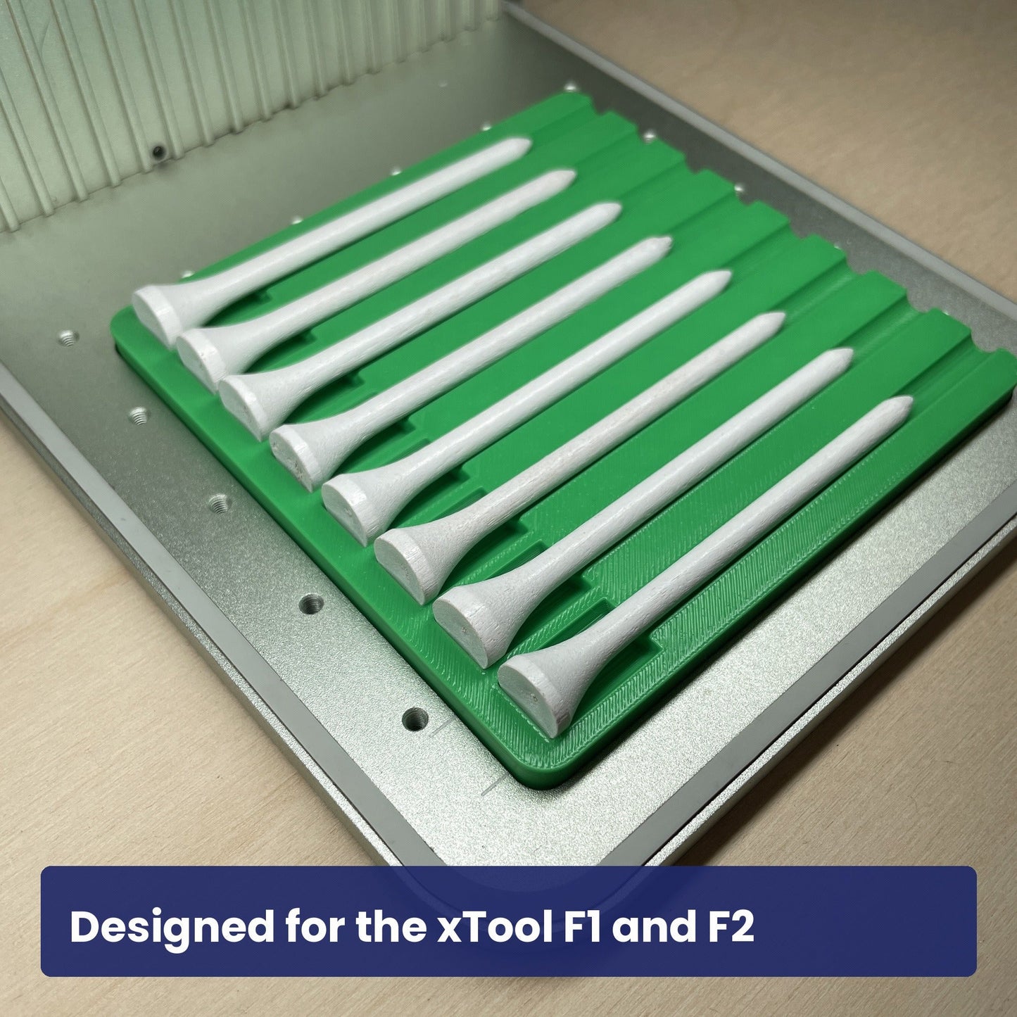 Samcraft golf tee jig seated in the xTool F1 base plate, loaded with white golf tees.