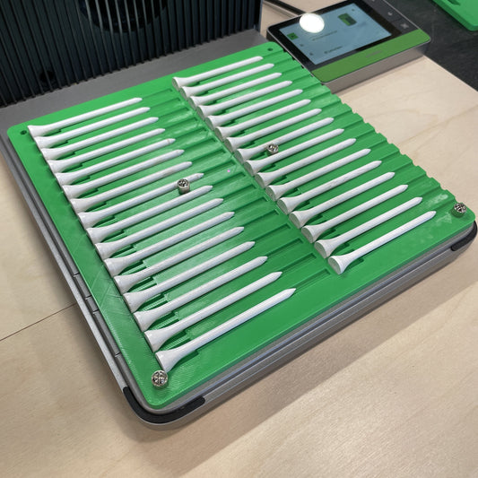Samcraft green golf tee jig in an xTool F1 Ultra laser bed, holding a full row of white golf tees.