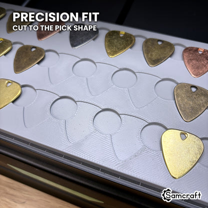 Close-up of the Samcraft xTool Omni guitar pick pockets, each cut to the pick outline so the pick seats without shifting.