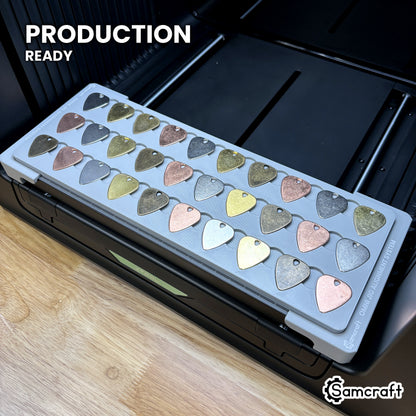 Samcraft guitar pick jig loaded with picks on the xTool Omni UV printer bed, set up for production runs.