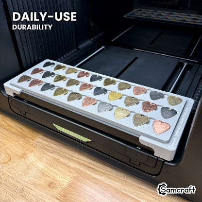 Samcraft xTool Omni guitar pick jig held in hand, showing the durable one-piece construction built for daily use.