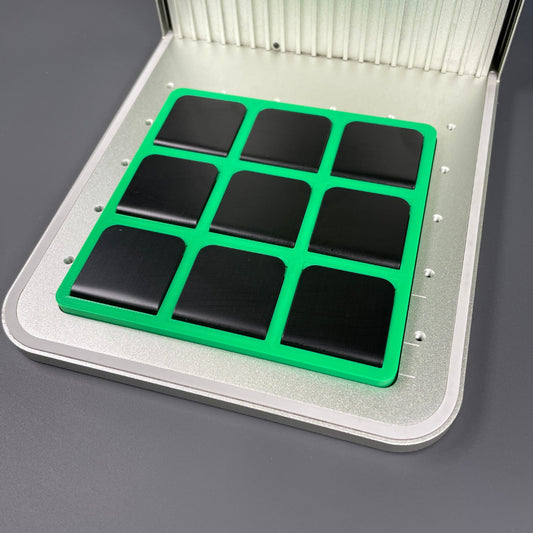 Samcraft green hat brim clip jig in an xTool F1 laser bed, holding a full grid of nine black hat clips.