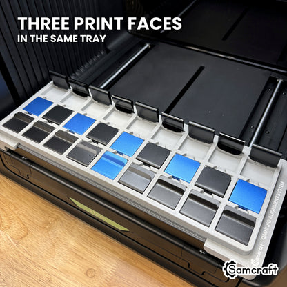 Samcraft xTool Omni hat clip jig with a row of clips standing on end alongside flat-seated clips, printing three faces in the same tray.