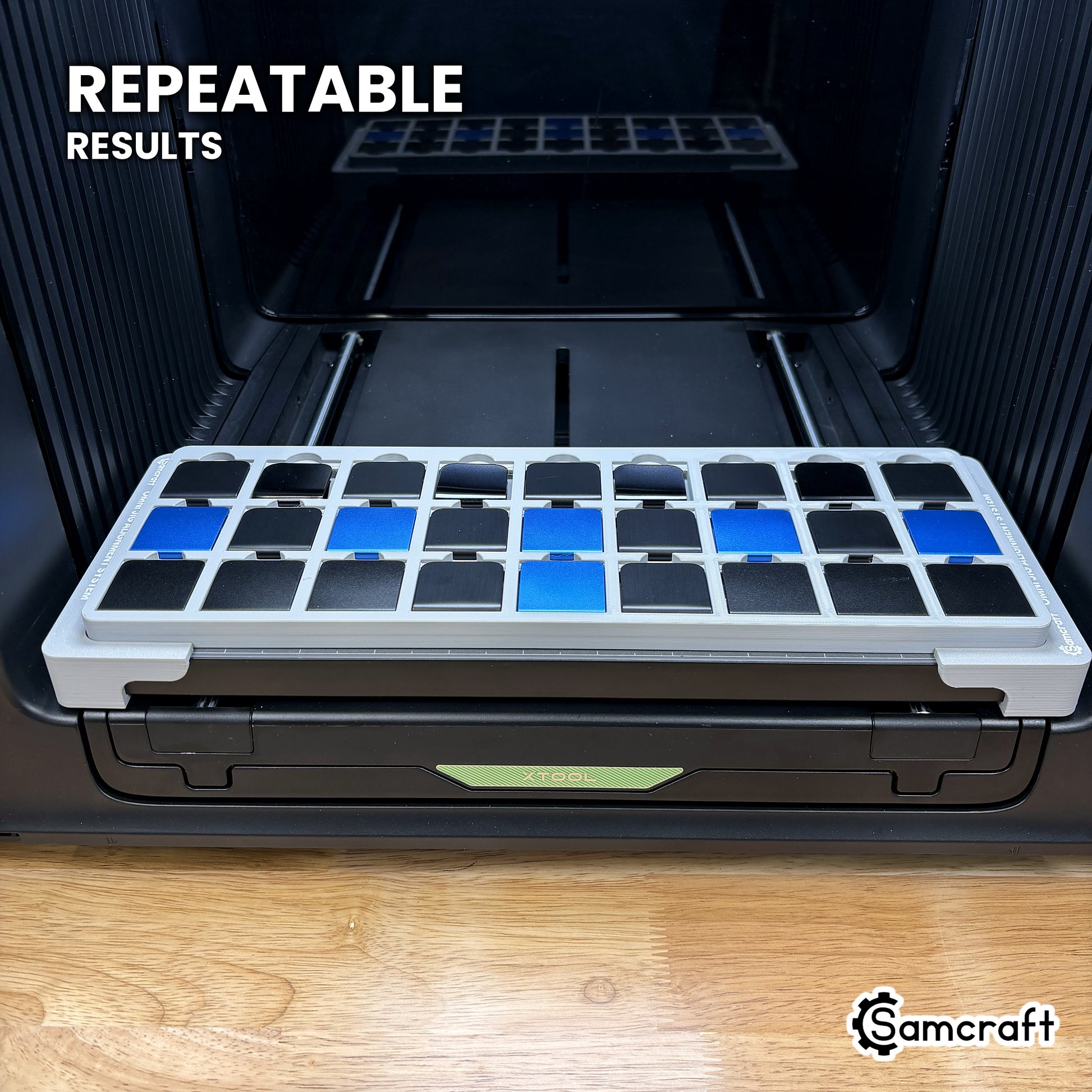Angled view of the Samcraft hat clip jig on the xTool Omni printer bed, loaded with twenty-seven clips for repeatable results.