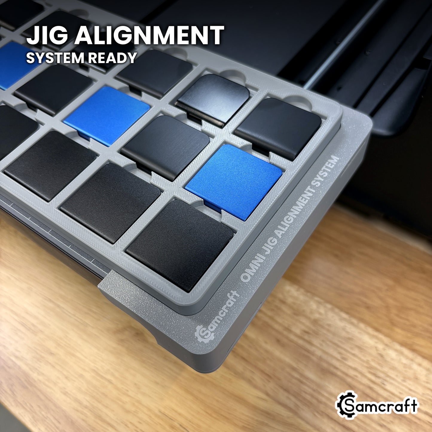 Samcraft hat clip jig seated on the optional Samcraft Omni Jig Alignment System, the alignment system lettering visible along the edge.