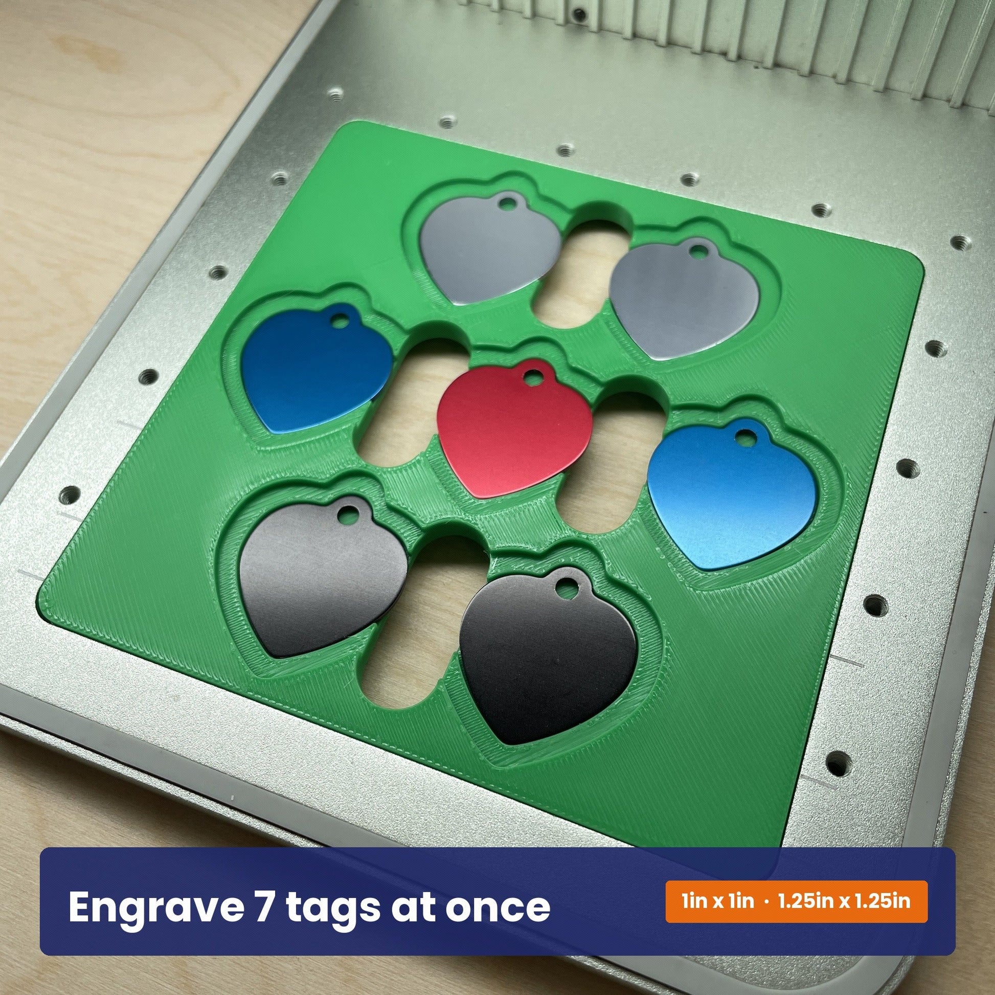 Heart pet tag jig holding seven tags at once, showing the two tag sizes it accepts.