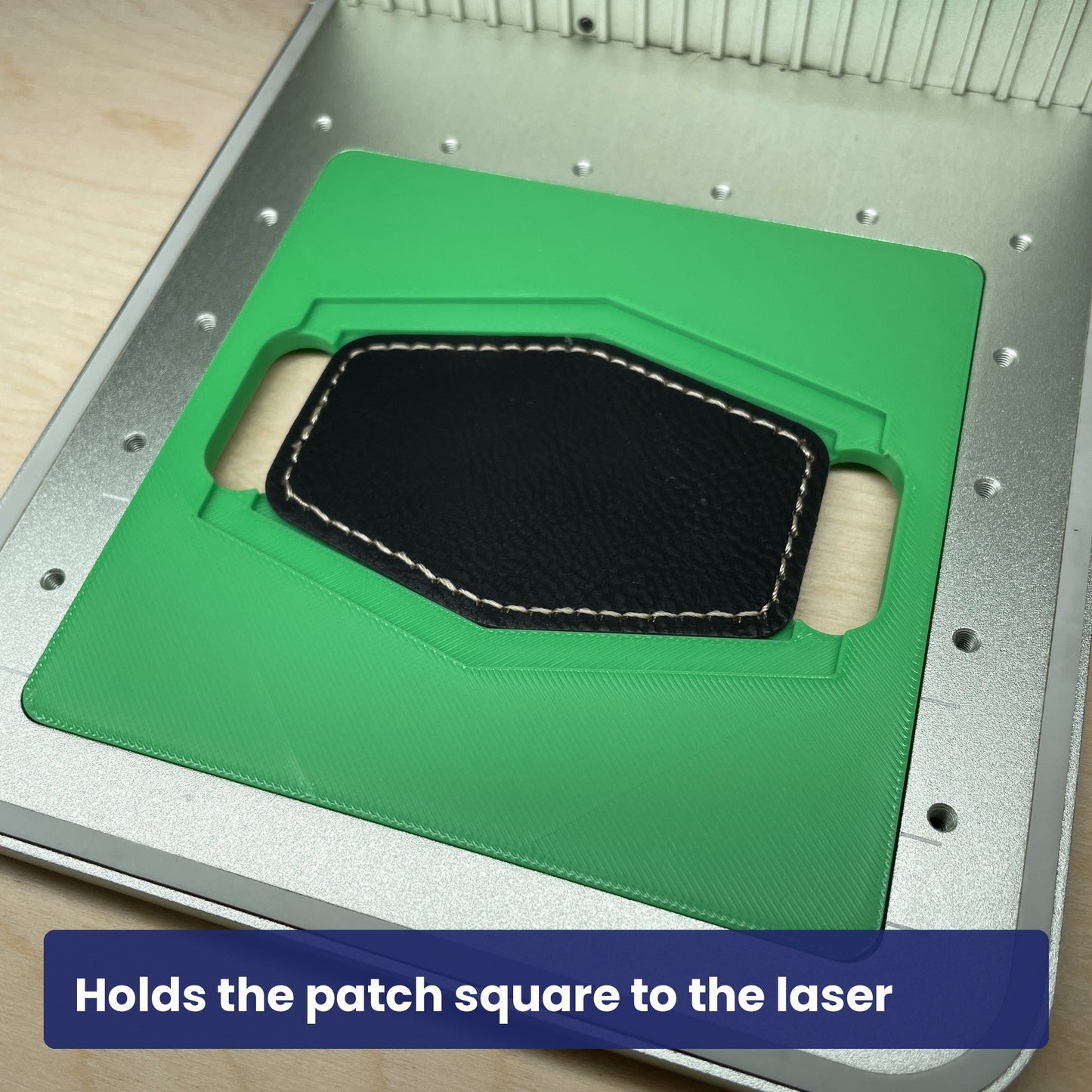Black hex leatherette patch seated square in the Samcraft jig, ready to engrave.