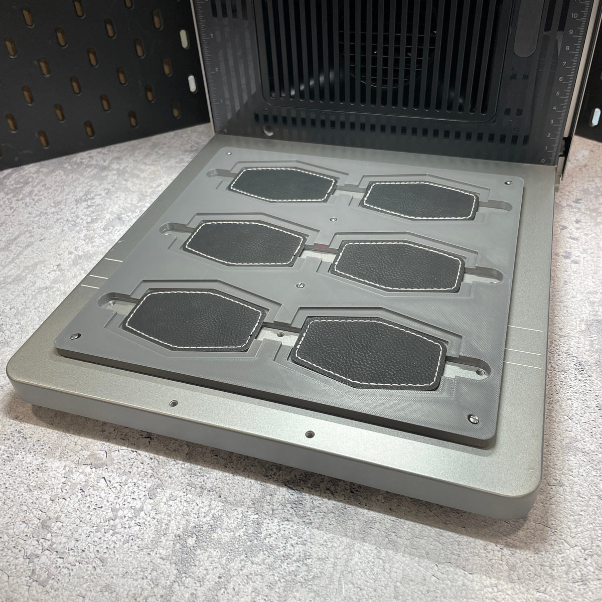 Samcraft hex patch jig on the xTool F2 Ultra bed, holding hexagonal leatherette patches.