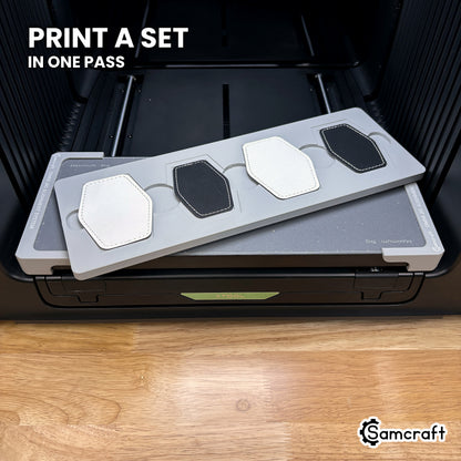 Four printed hexagon leatherette patches in the Samcraft xTool Omni jig, a matching set finished in a single job.