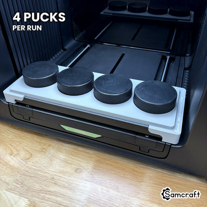 Samcraft hockey puck jig for the xTool Omni loaded with four regulation hockey pucks, a full four-puck run in a single pass.