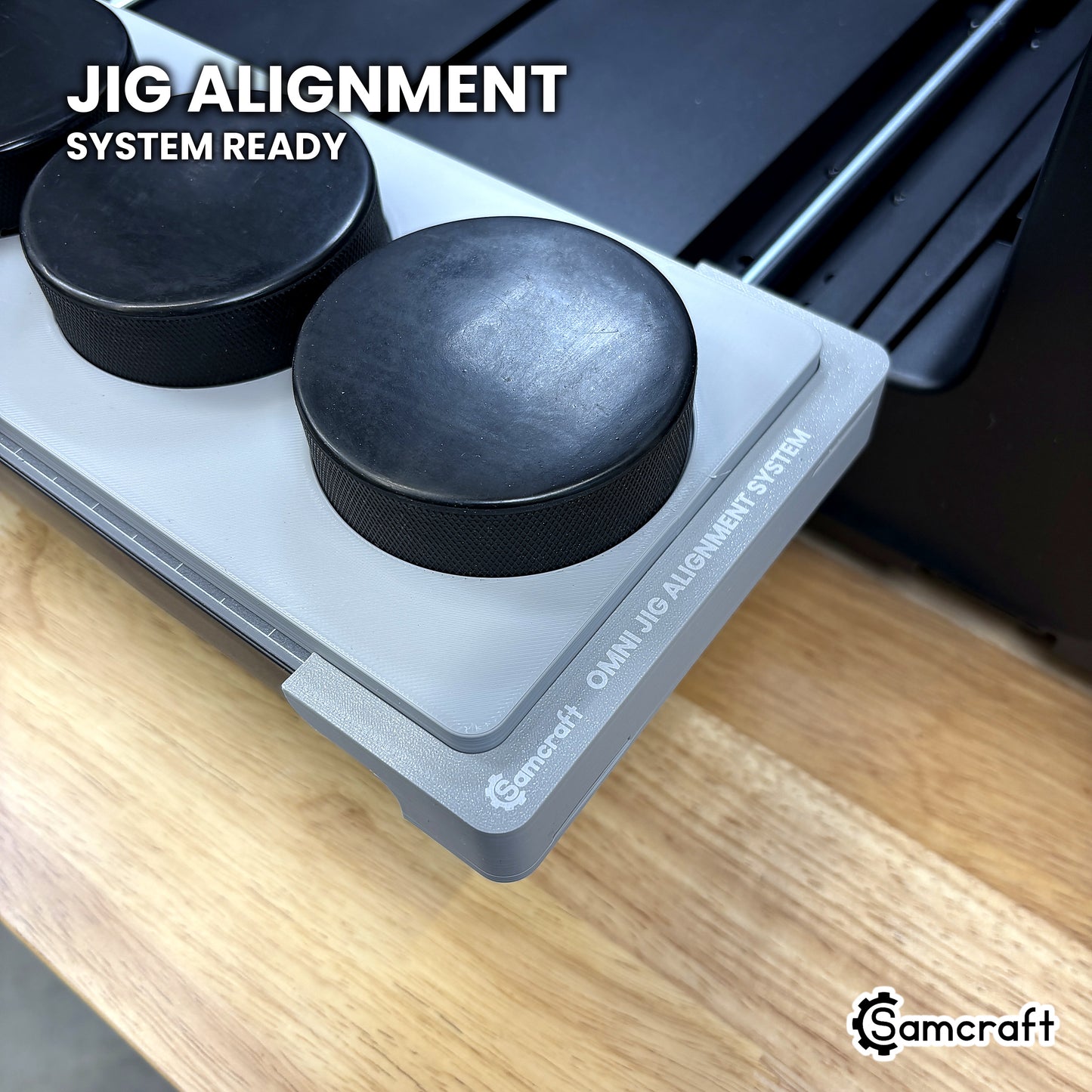 Close-up of the Samcraft hockey puck jig seated on the Omni Jig Alignment System, the alignment system lettering visible along the edge.