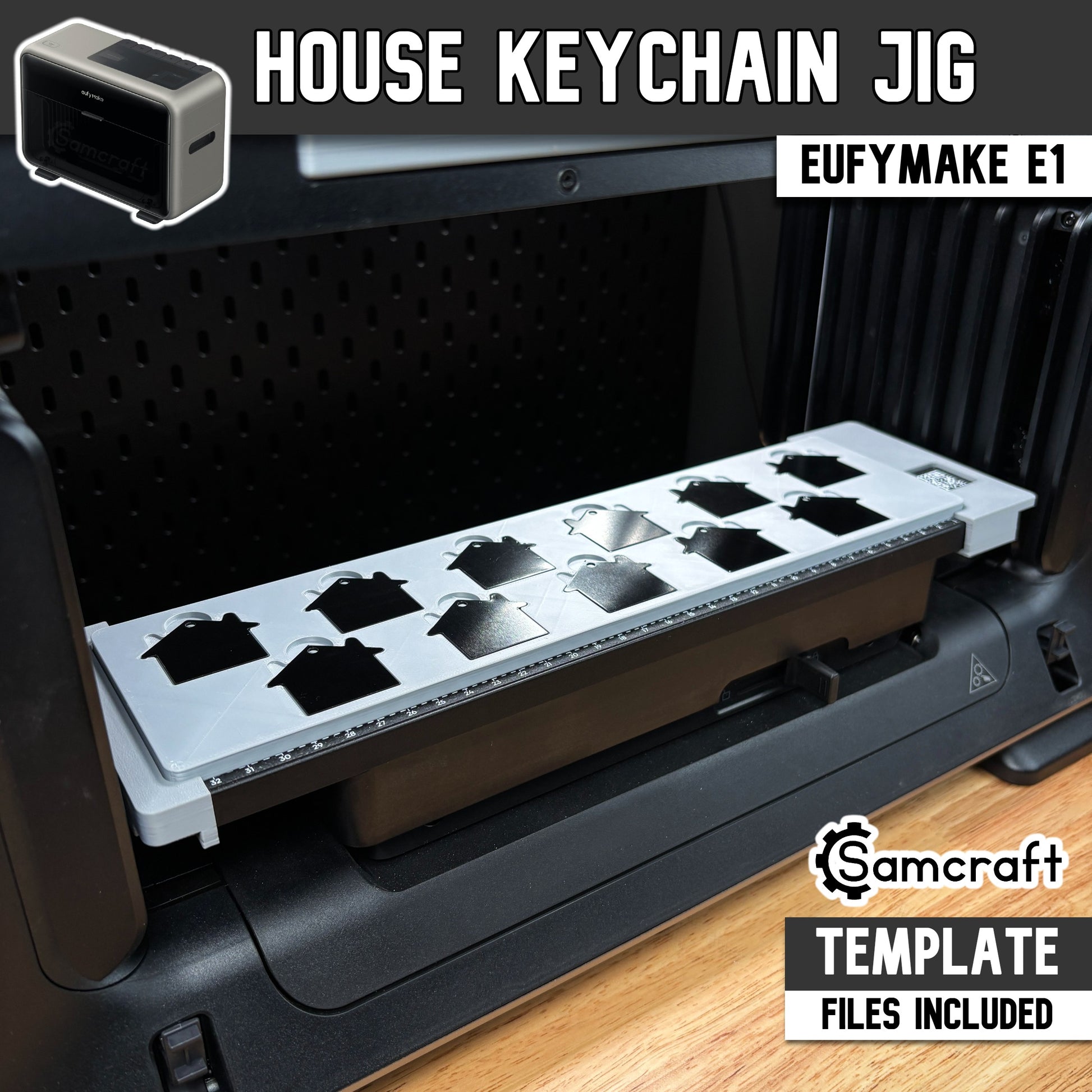Main product image of the Samcraft House Tag Keychain Jig for the eufyMake E1 UV printer, showing black and silver house-shaped keychain blanks in a gray tray; template files included.