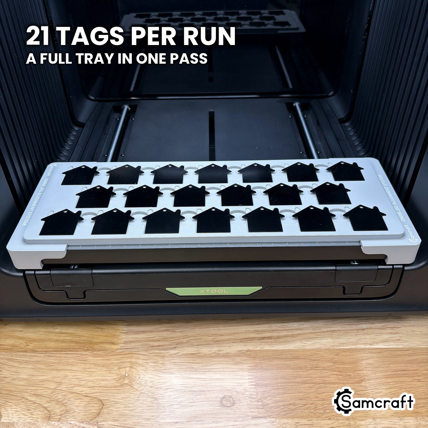 Samcraft house tag jig for the xTool Omni loaded with twenty-one tags in three staggered rows of seven, a full tray in one pass.