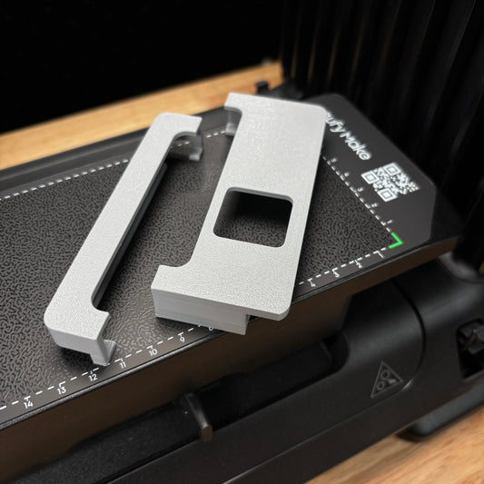 Samcraft jig alignment system on the eufyMake E1 print bed, an edge rail and a corner bracket positioned for drop-in jig layouts.