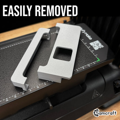Jig Alignment System for the eufyMake E1 — two gray 3D-printed alignment guides resting loosely on the printer's textured bed, showing how easily they are removed.