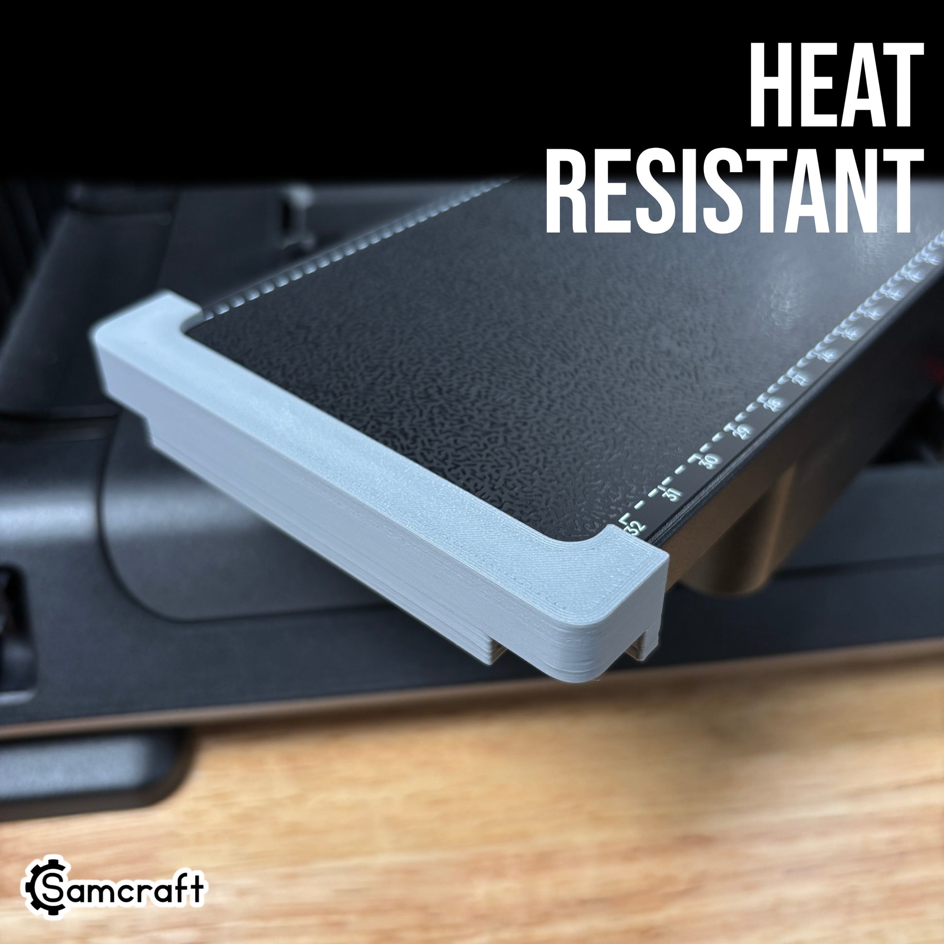 Jig Alignment System for the eufyMake E1 — close-up of the gray 3D-printed corner alignment bracket fitted to the printer's black textured bed alongside the built-in ruler, highlighting the heat-resistant material.