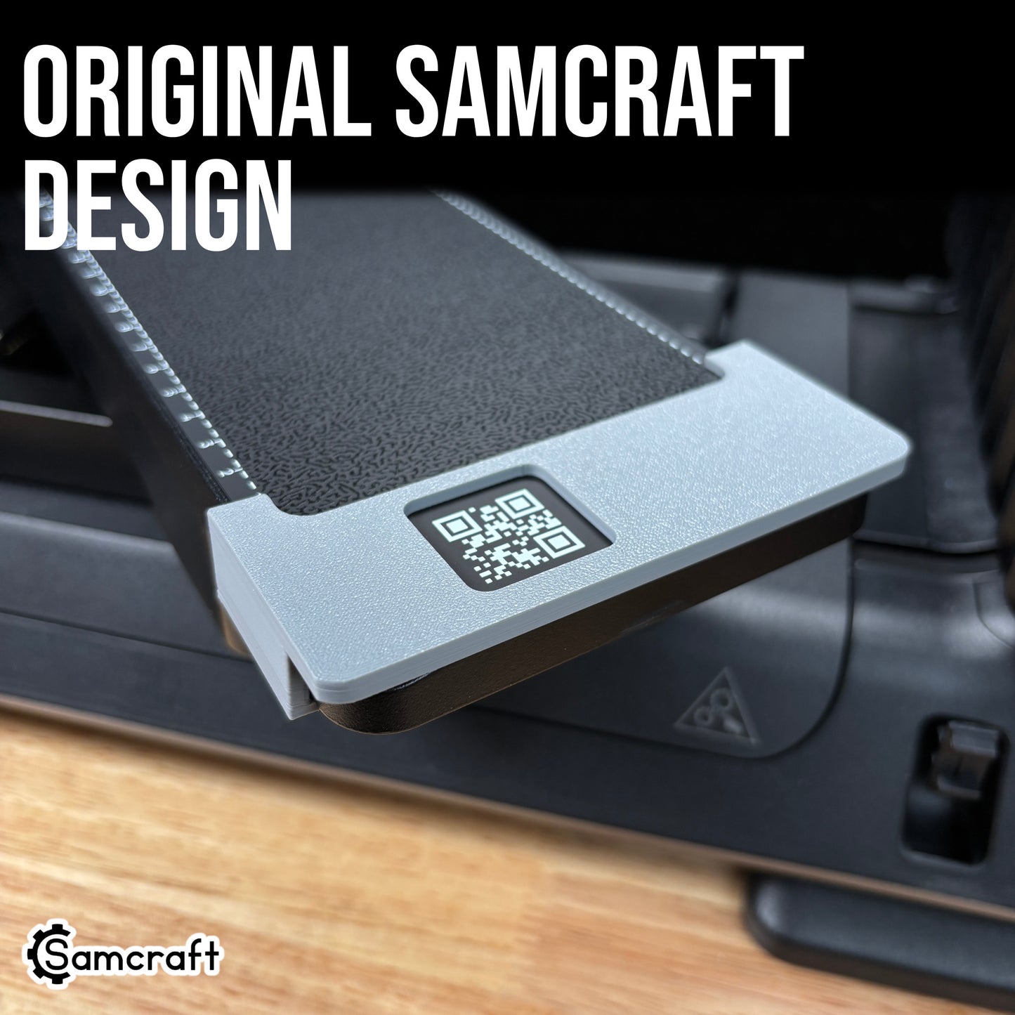 Jig Alignment System for the eufyMake E1 — angled close-up of the gray 3D-printed corner alignment bracket with exposed QR code fitted to the edge of the printer's black textured bed, an original Samcraft design.