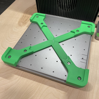 Samcraft jig baseplate mounted in an xTool F1 Ultra, a silver plate with green corner brackets ready to accept a jig.