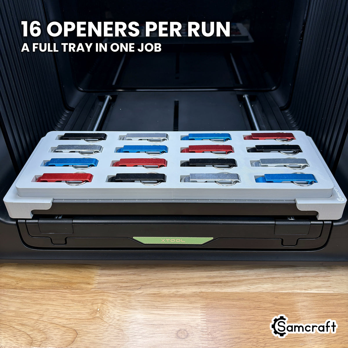 Top view of the Samcraft keychain bottle opener jig for the xTool Omni with all sixteen pockets filled, a full tray ready to run in one job.