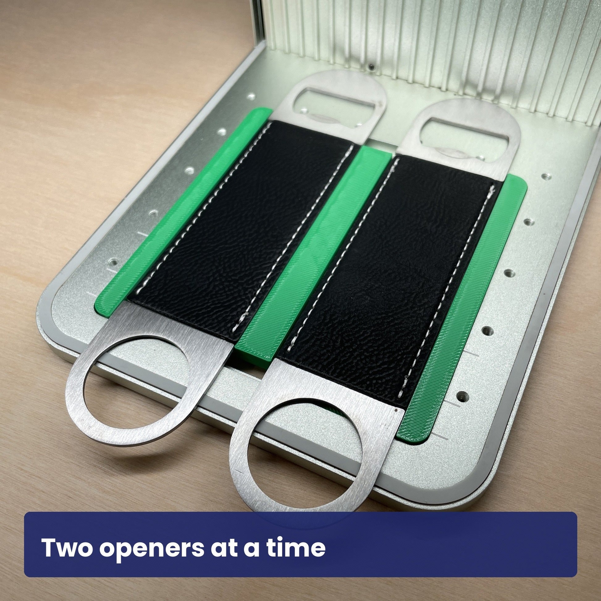 Samcraft large bottle opener jig holding two black leather bottle openers side by side in the laser bed.