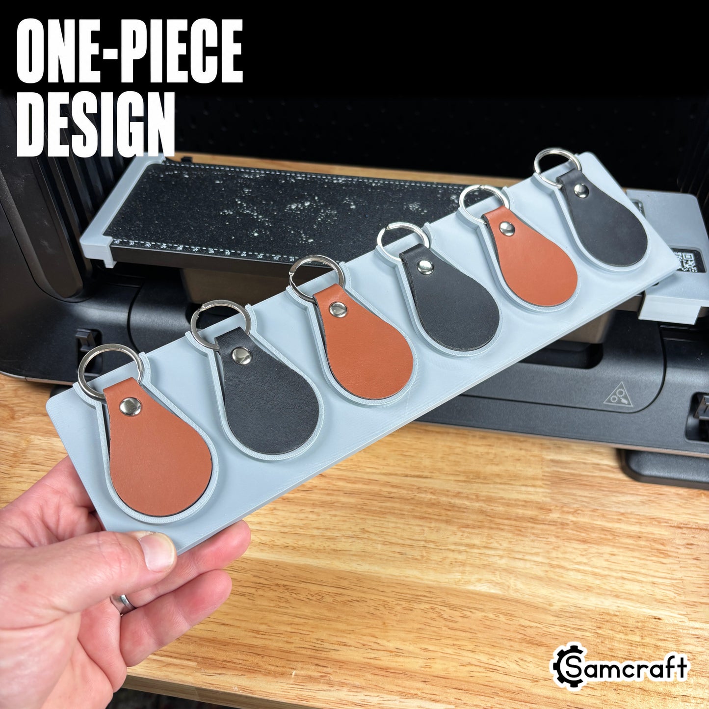 leather-key-fob-jig-eufymake-one-piece-design.jpg

Leather Key Fob Jig for the eufyMake E1 — hand holding the gray one-piece 3D-printed tray loaded with six leather key fobs in cognac and black, each in its own molded pocket, showing the solid single-piece design.