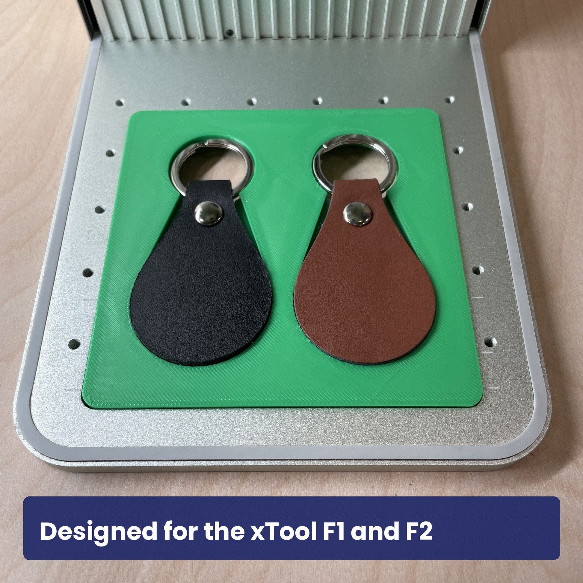 Samcraft leather key fob jig seated in the xTool F1 base plate with a leather fob in the recess.