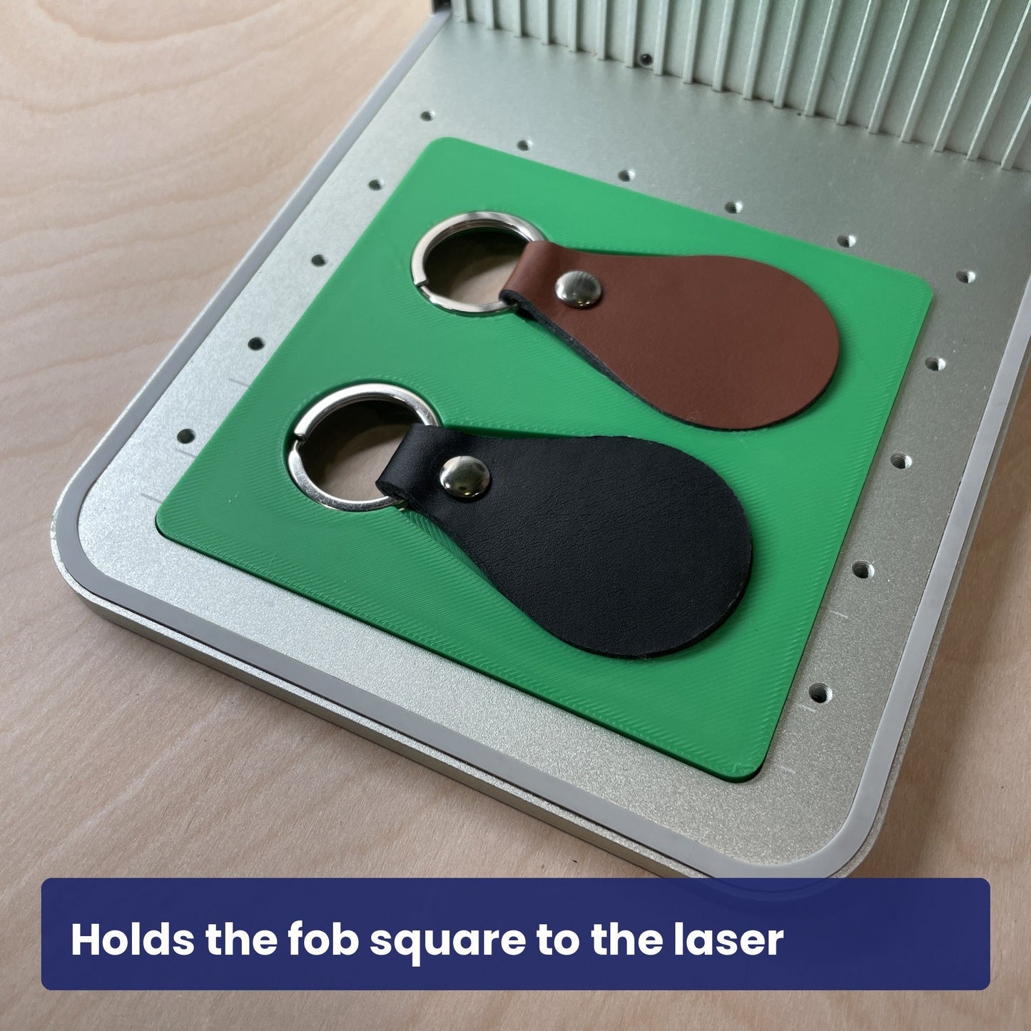 Leather key fob held square in the Samcraft jig, rotated to show the fit.