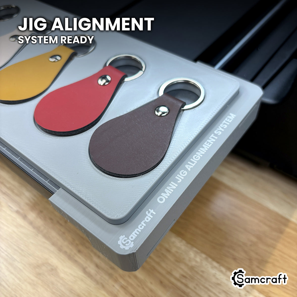 The Samcraft leather key fob jig on the Omni Jig Alignment System, the OMNI JIG ALIGNMENT SYSTEM marking and Samcraft mark clearly visible.