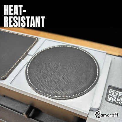 Heat-resistant Samcraft Leather/Silicone Drink Coaster Jig holding a round stitched black leather coaster in a recessed gray pocket on the eufyMake E1.