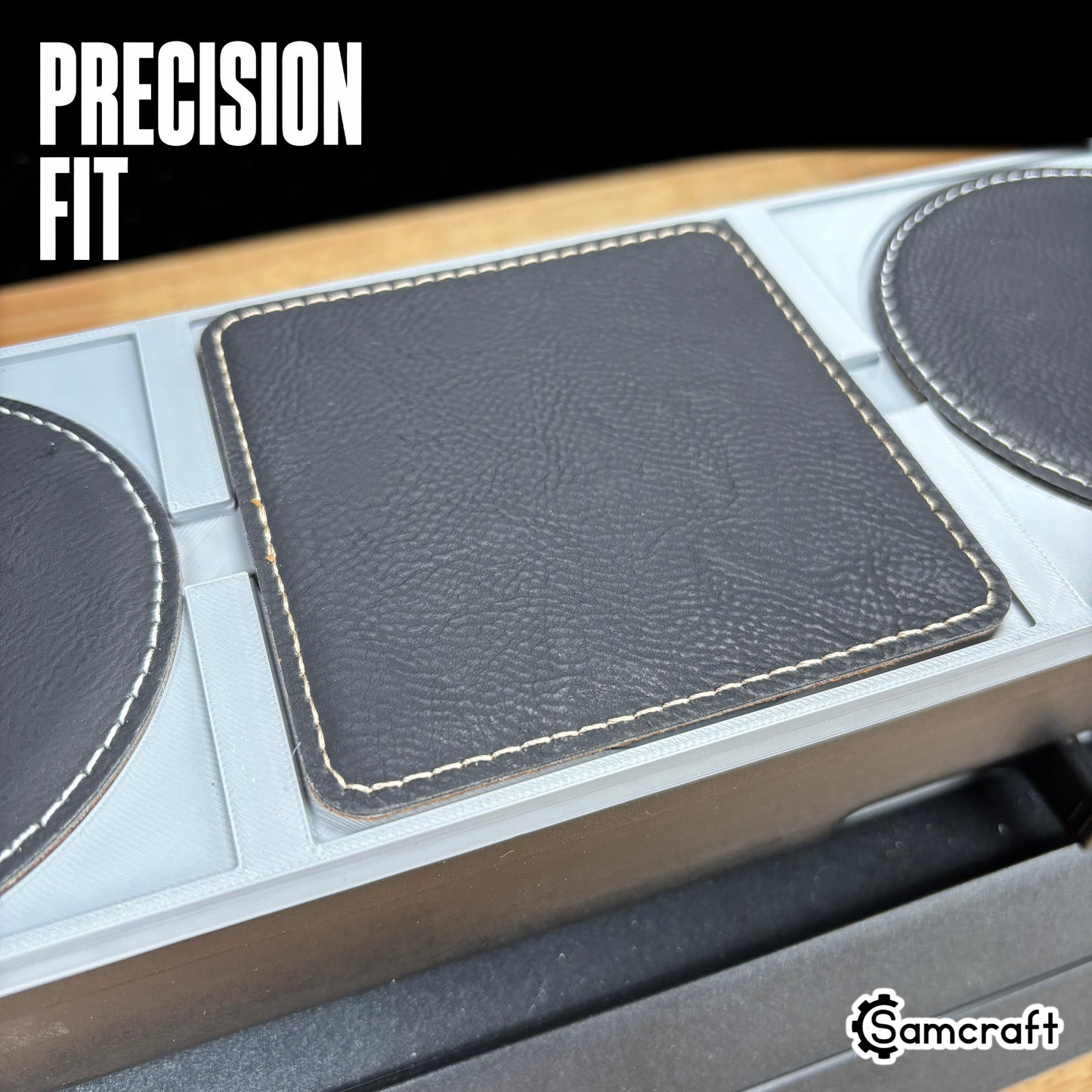 Precision-fit Samcraft Leather/Silicone Drink Coaster Jig holding square and round black leather coasters snugly in recessed gray pockets on the eufyMake E1.