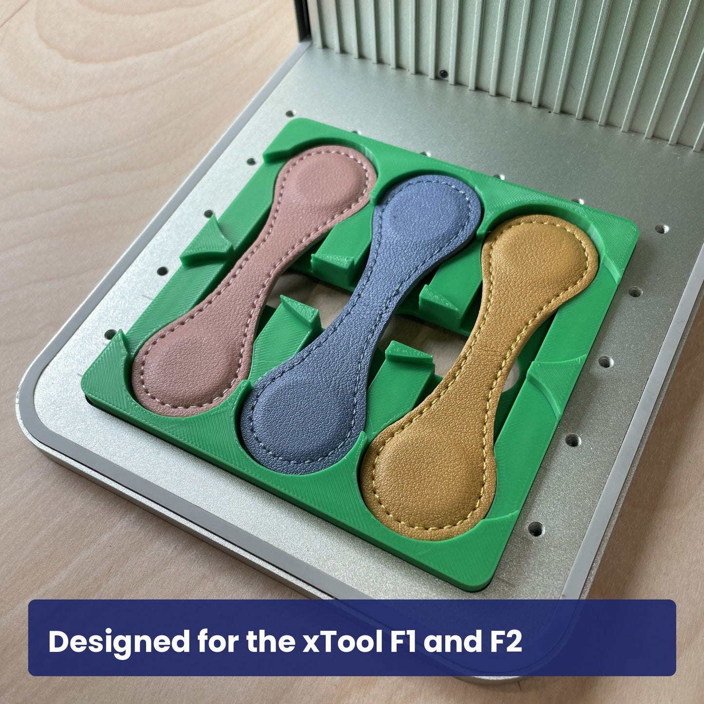 Samcraft magnetic bookmark jig seated in the xTool F1 base plate with a leather bookmark in place.