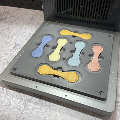 Samcraft magnetic bookmark jig on the xTool F2 Ultra bed, holding wrap-style leather bookmarks in pastel colours.