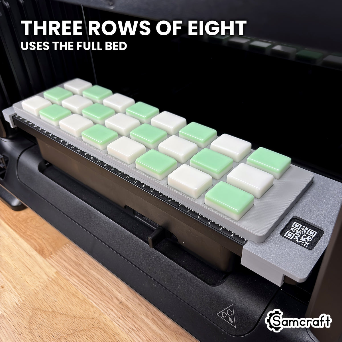 Angled view of the Samcraft eufyMake E1 mahjong tile jig showing three rows of eight tiles along the length of the print bed.
