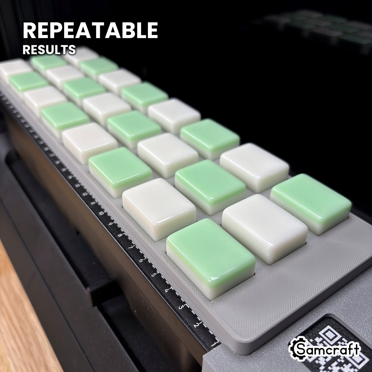 Angled view of white and green mahjong tiles lined up in matching pockets of the Samcraft eufyMake E1 jig, every tile in the same position.